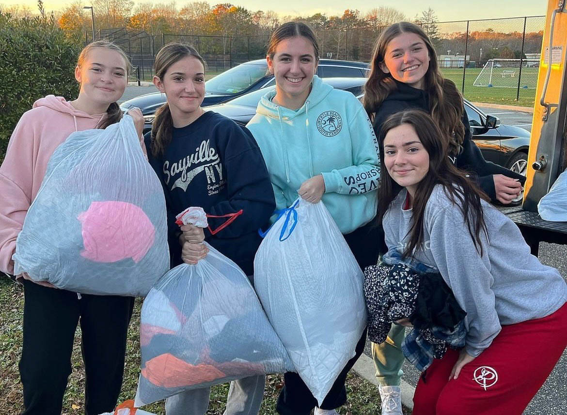 Team posing after clothing drive success