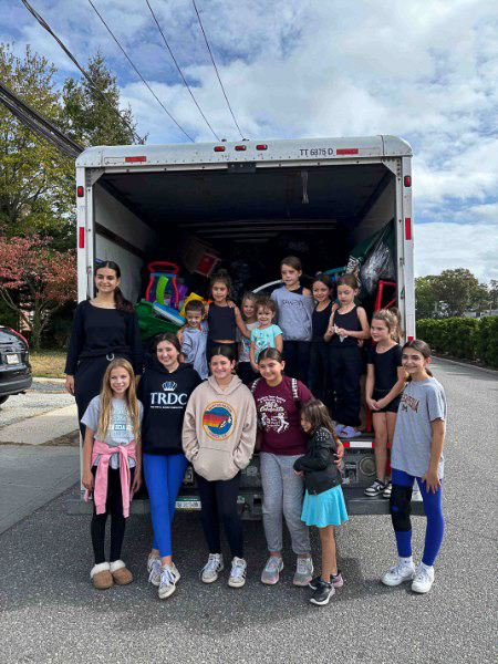 Family donating gently used clothing to support youth sports team