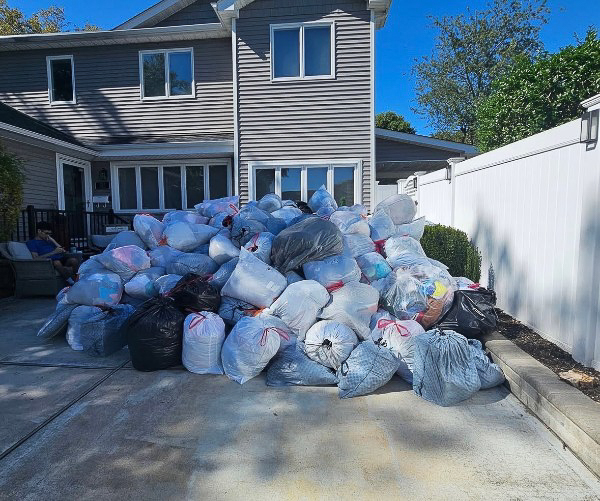 Donation bags neatly stacked for pickup by Go Green Clothing Drive